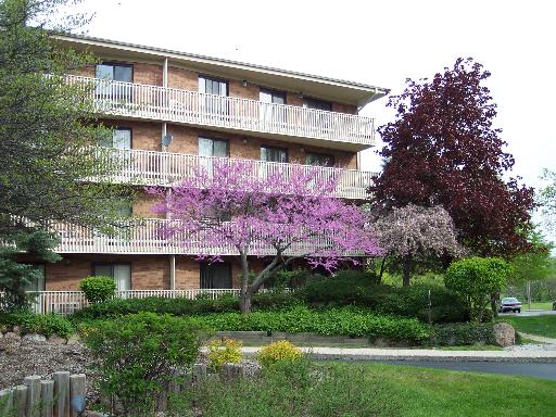 Front view of a multi-story residential building with balconies.