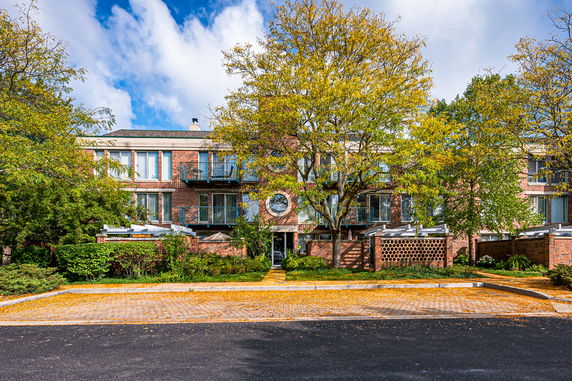 Front view of a two-story brick building with balconies.