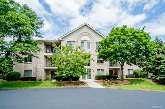 Front view of a multi-story residential building with a pitched roof.