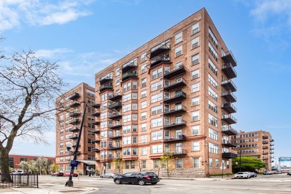 Front view of a multi-story apartment building with balconies.
