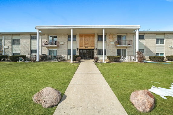Front view of a two-story residential building with balconies.