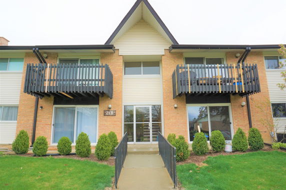 Front view of a two-story building with balconies.