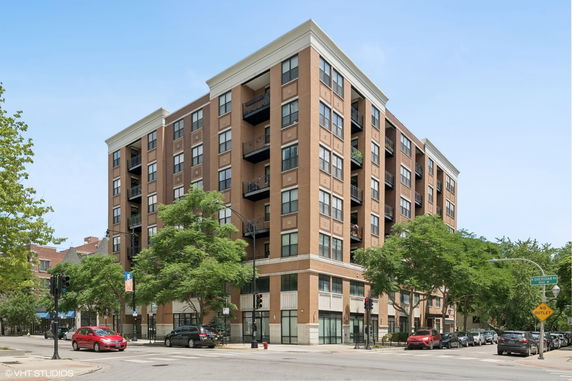 Front view of a multi-story apartment building with multiple balconies.