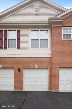 Front view of a multi-story house with a double garage.