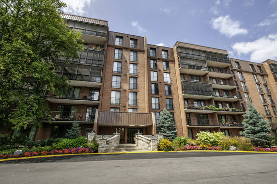 Front view of a multi-story apartment building with balconies.