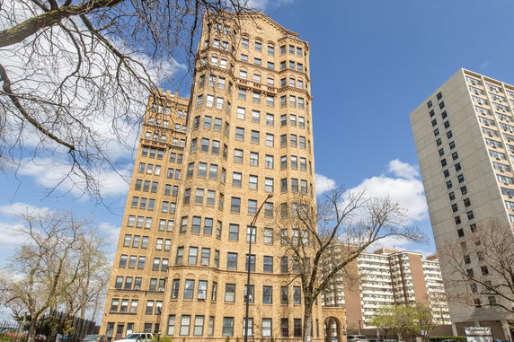 Front view of a multi-story brick apartment building.