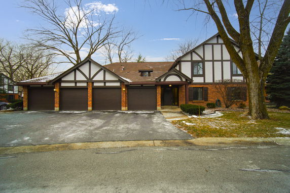 Front view of a multi-story house with attached garages.