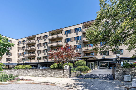 Front view of a multi-story apartment building with balconies.