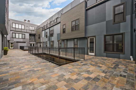 Courtyard view of a modern multi-story building with large windows.