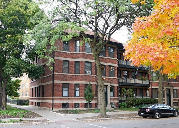Front view of a multi-story brick apartment building.