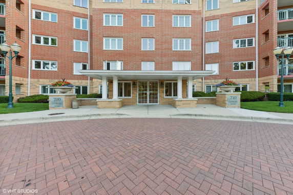 Front view of a multi-story brick building with an entrance canopy.