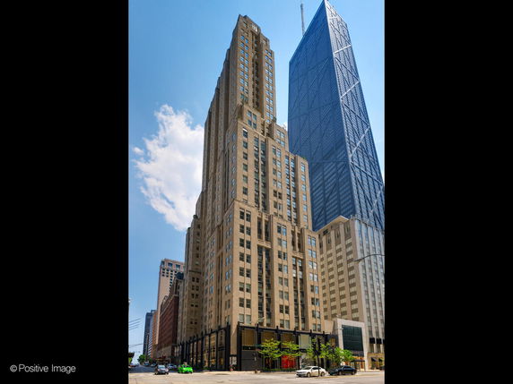 Front view of a tall building with multiple floors in an urban setting.