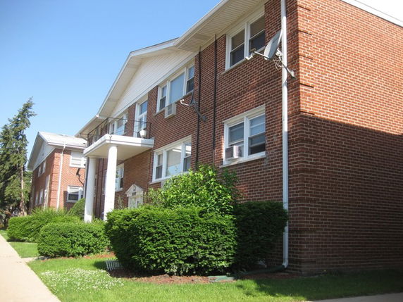 Front view of a brick two-story building with white trim.