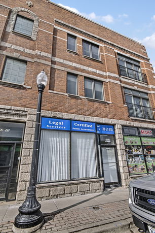 Street view of a brick commercial building with legal services and accountant office.