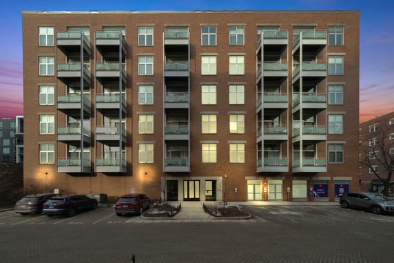 Front view of a multi-story residential building with balconies.