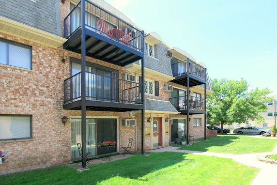 Front view of a multi-story residential building with balconies.