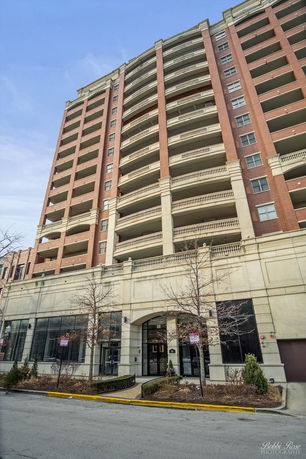 Front view of a multi-story residential building with balconies.