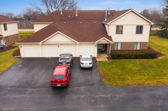 Front view of a two-story house with a three-car garage.