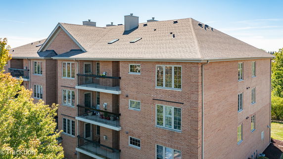 Front view of a multi-story brick building with balconies.
