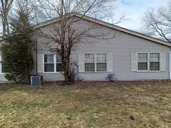 Front view of a single-story house with siding and multiple windows.