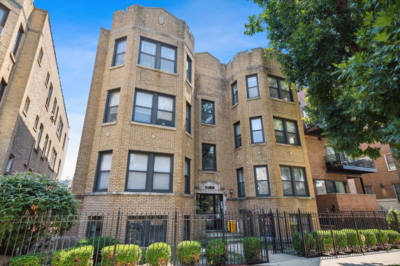 Front view of a multi-story brick apartment building.