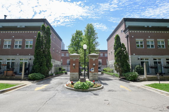 Front view of a gated brick residential building complex