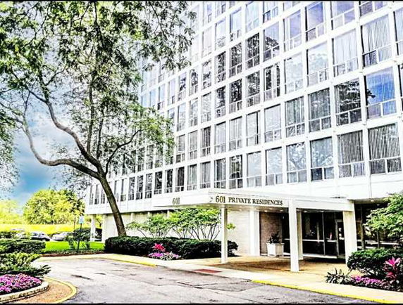 Front view of a multi-story residential building labeled 601 Private Residences.