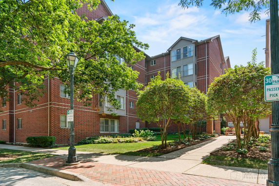 Front view of a multi-story brick apartment building.