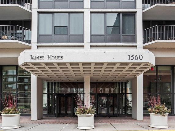 Front view of a multi-story building with a covered entrance.