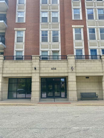 Front view of a multi-story building with brick and stone facade.