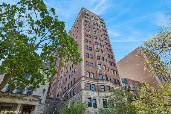 Front view of a tall multi-story brick building.