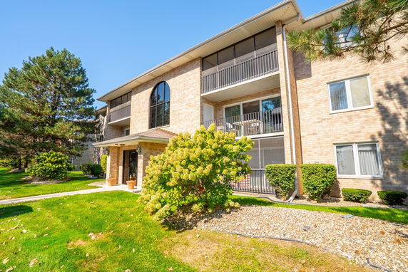 Front view of a multi-story residential building with balconies.
