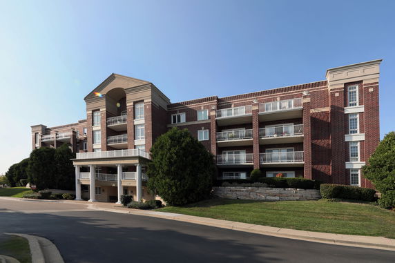 Front view of a multi-story brick building with balconies.