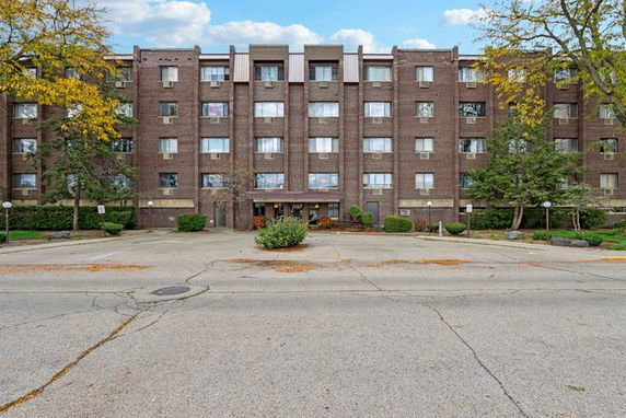 Front view of a multi-story brick apartment building.
