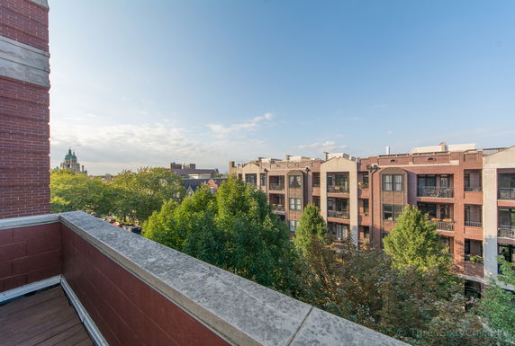 Wide-angle view of surrounding buildings from a balcony.