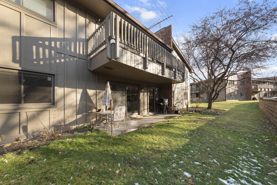 Outdoor view of a two-story building with balconies and a patio.