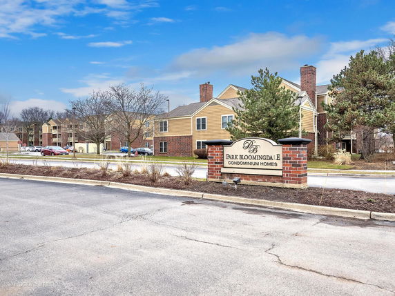 Front view of a condominium complex with multiple residential buildings.