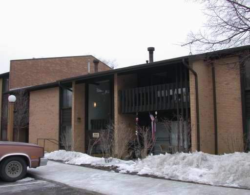 Front view of a two-story building with brick exterior and balconies.