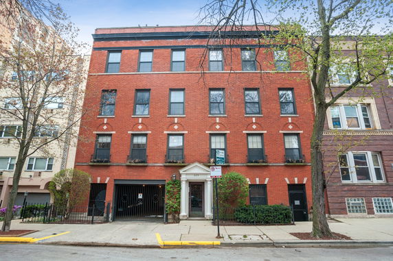 Front view of a multi-story brick building with multiple windows.