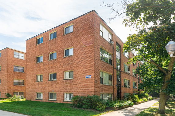 Front view of a three-story brick apartment building.