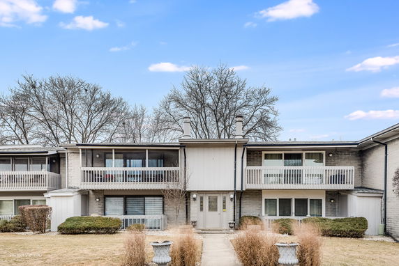 Front view of a two-story residential building with balconies.
