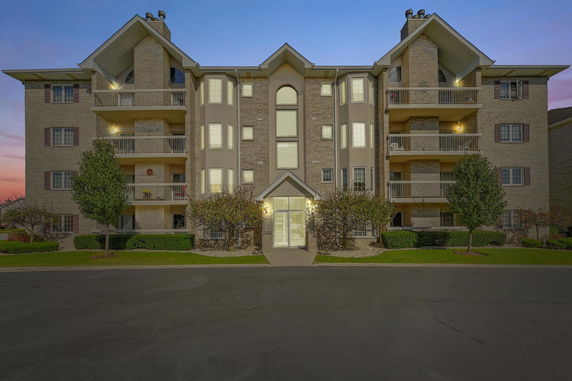Front view of a multi-story residential building with balconies.