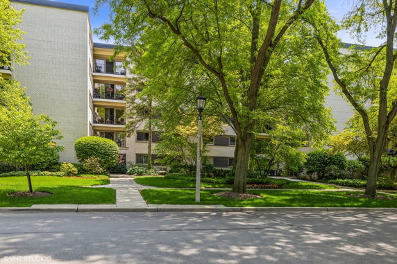 Front view of a multi-story apartment building with balconies.