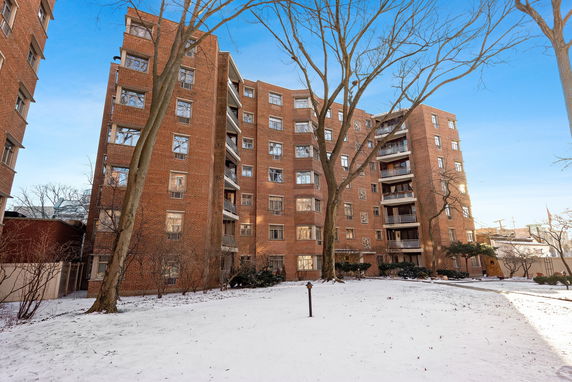 Front view of a multi-story brick apartment building.