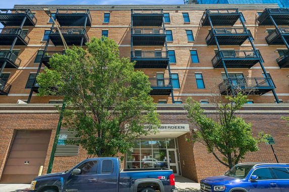 Front view of a multi-story brick building with balconies.