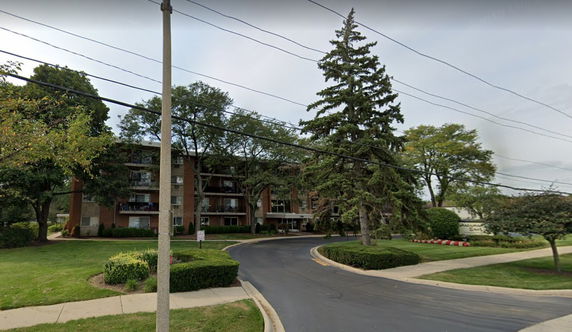 Front view of a multi-story apartment building with balconies.