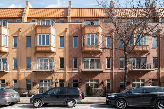 Front view of a multi-story residential building with balconies.