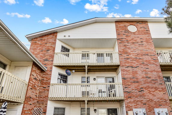 Front view of a multi-story building with balconies.