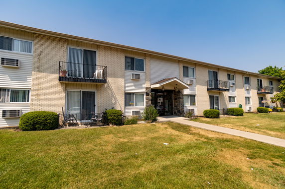 Front view of a two-story apartment building with balconies.