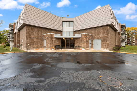 Front view of a brick building with multiple stories and a modern design.